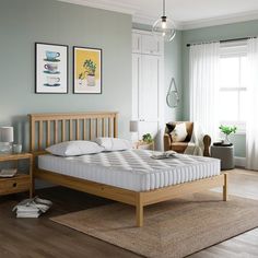 a bedroom with blue walls and wooden furniture