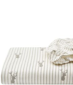 a white and brown striped bed spread with deer on it