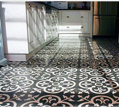 a kitchen with black and white tile flooring