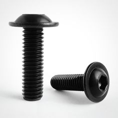 a black screw and a button on a white background