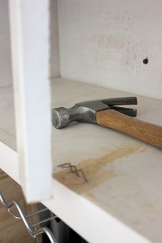 there is a pair of pliers on the shelf next to some tools in it