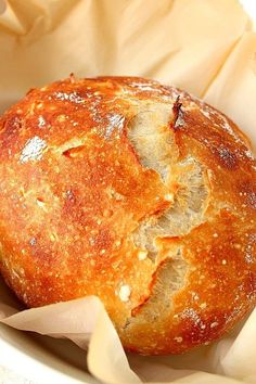 a loaf of bread in a white bowl