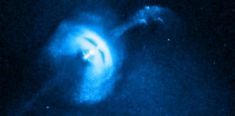 an image of a blue object in the dark with light coming from it's center