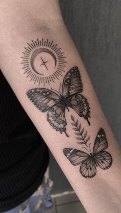 a woman's arm with three butterflies on it