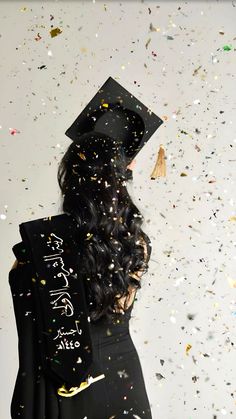 a woman wearing a graduation cap and gown with confetti all over her head