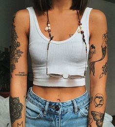 a woman with tattoos on her arms and chest is shown in the instagramr