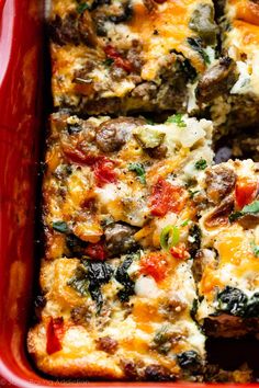 a casserole dish with meat, cheese and vegetables in a red baking dish