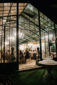 a group of people sitting at tables inside of a building