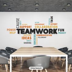 a room with a table and chairs in front of a wall that says teamwork