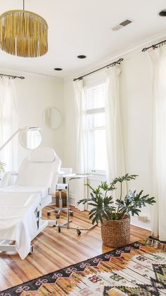 a living room with a white piano in the corner and a rug on the floor