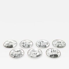 six plates with boats on them sitting in front of a white background and one is empty