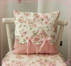 a white chair with pink flowers on it and a pillow that says, never before