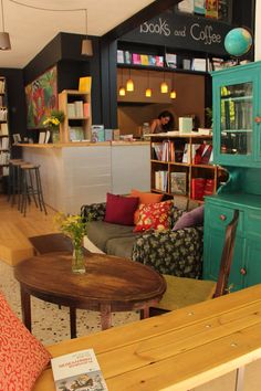 the interior of a coffee shop with colorful furniture