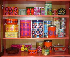 the shelves are filled with different types of books and other decorative items, including candles