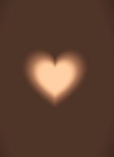 a blurry image of a heart on a brown background