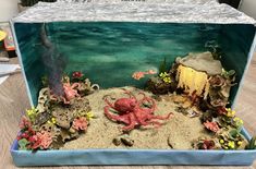 an underwater scene with corals and octopuses in the water, under a plastic sheet