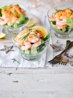 shrimp salad served in small glass bowls with lemon wedges