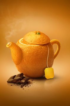 an orange with a teapot and some chocolate