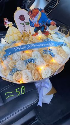 a birthday cake with frosting roses in the shape of beauty and the beast on it