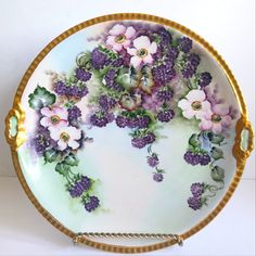 a decorative plate with flowers painted on it