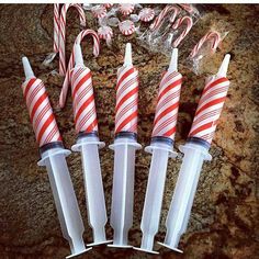 candy canes are lined up in plastic tubes