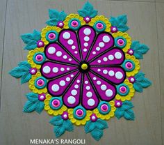 this is an image of a colorful flower design on the floor in front of a wall