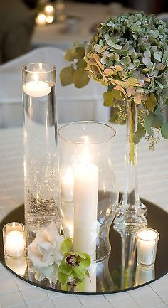 a table with candles and flowers on it