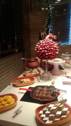 an assortment of desserts and pastries on a table