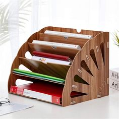 a wooden desk organizer holds several files and folders