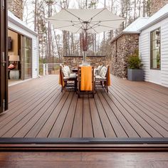 an outdoor deck with chairs and umbrellas on it