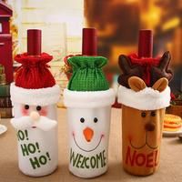 three christmas wine bottles sitting on top of a table with santa hats and reindeer noses