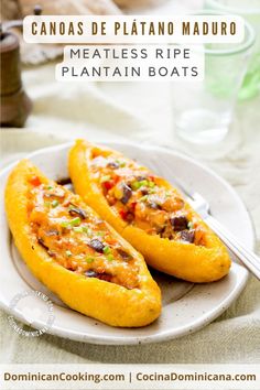 two stuffed peppers sitting on top of a white plate