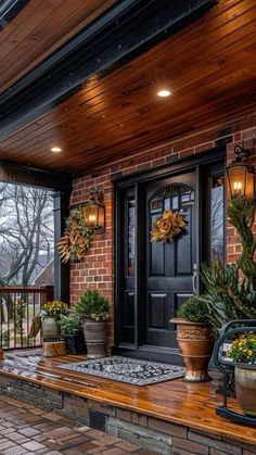 the front porch is decorated with potted plants