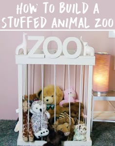 stuffed animals are in a white cage with the word zoo on it's side