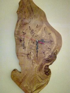 a clock made out of wood on the wall