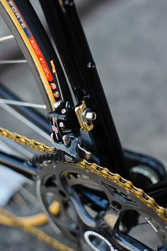 the bike is parked on the side of the road with its chain attached to it