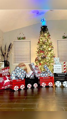 a christmas tree is surrounded by boxes and presents