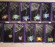 the bulletin board is decorated with colorful handprints and spider webs on it