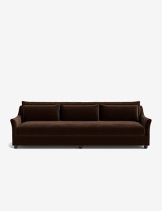 a brown couch sitting on top of a white floor