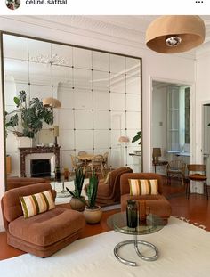 a living room filled with furniture and a large mirror