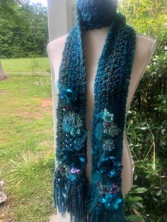 Women bohemian crochet flowers scarf it's 82 inch long and 3wide it's light in weight and soft unique one kind it can be worn in different style it's a statement piece All the flowers are hand stitch with some embroidered attached it's unique. Bohemian Crochet Yarn Scarves, Handmade Yarn Bohemian Scarves, Handmade Bohemian Yarn Scarves, Handmade Bohemian Yarn Scarf, Handmade Blue Yarn Scarves, Handmade Blue Yarn Scarf, Blue Bohemian Handmade Scarves, Blue Handmade Bohemian Scarves, Blue Bohemian Crochet Scarves