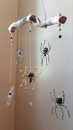 three spider mobiles hanging from the ceiling