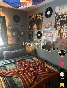 a bed room with a neatly made bed and pictures on the wall above it,