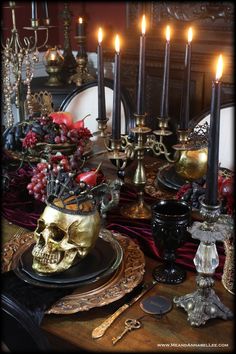 a table with candles and skulls on it