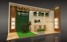 an exhibit booth with plants on the wall and green grass in the flooring area