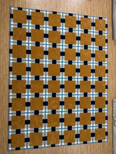 a brown rug with black and white squares on it