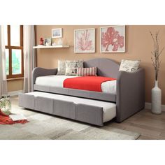 a day bed with a pull out trundle and storage underneath it in a living room