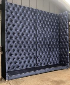 an upholstered wall in front of a building with a black cloth covering it