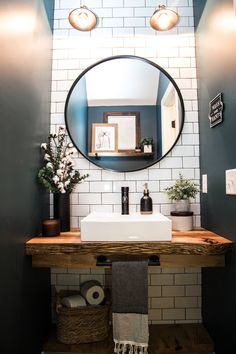 a bathroom sink with a mirror above it and towels on the shelf next to it