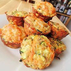 small muffins on a white plate sitting on a table